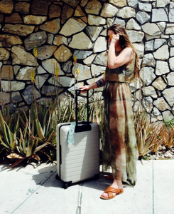 Emily Katz in Palm Springs with her Away Luggage and macrame luggage adornment for when we can travel again. 