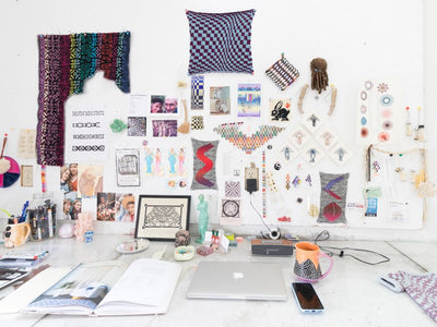 Elspeth Vance's knitting and macramé work space with vibrant patterns and inspiration mood boards