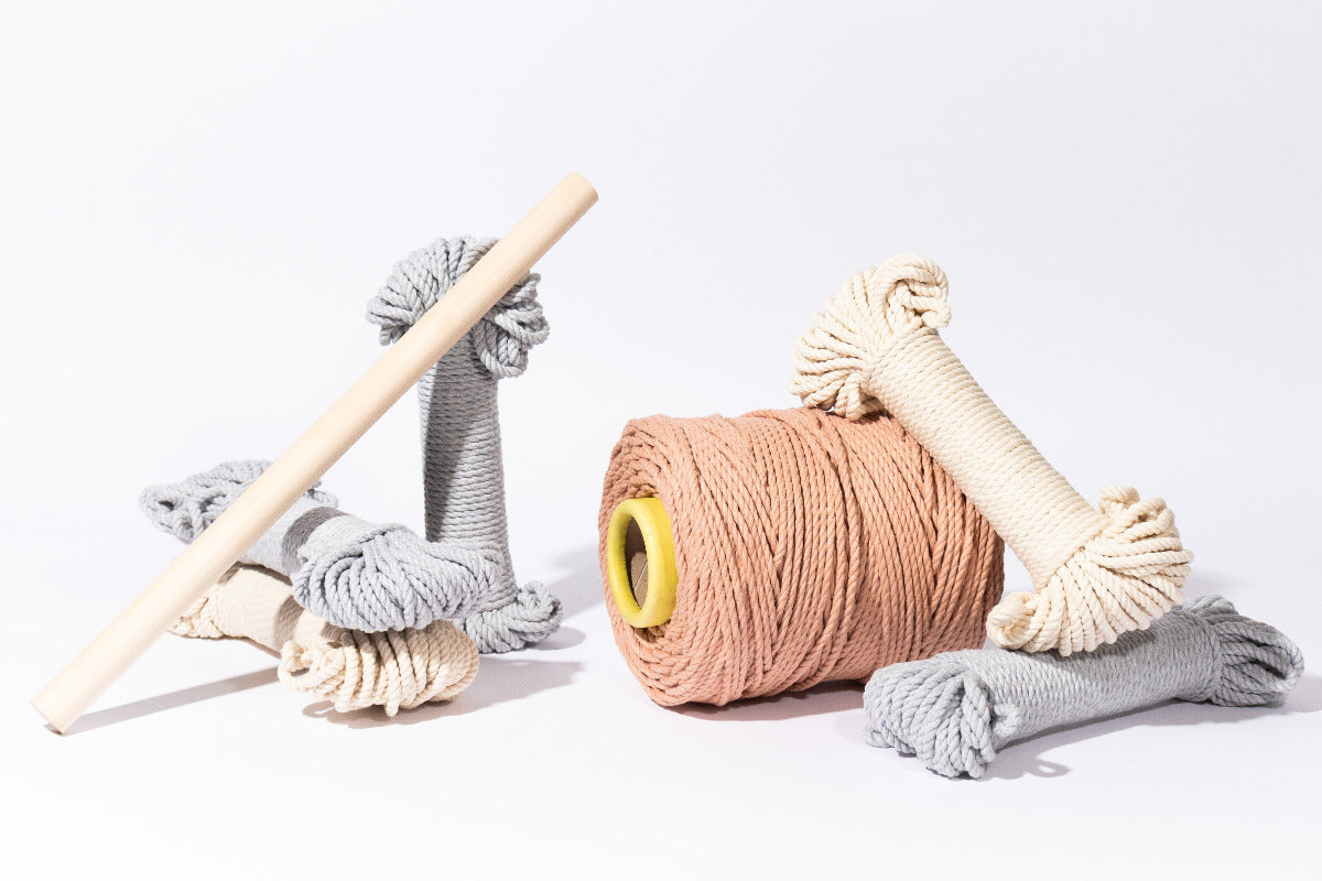 Supplies included in your kit include: 1 spool of peach, 3 bundles of light gray and 2 bundles of natural 5mm cotton rope