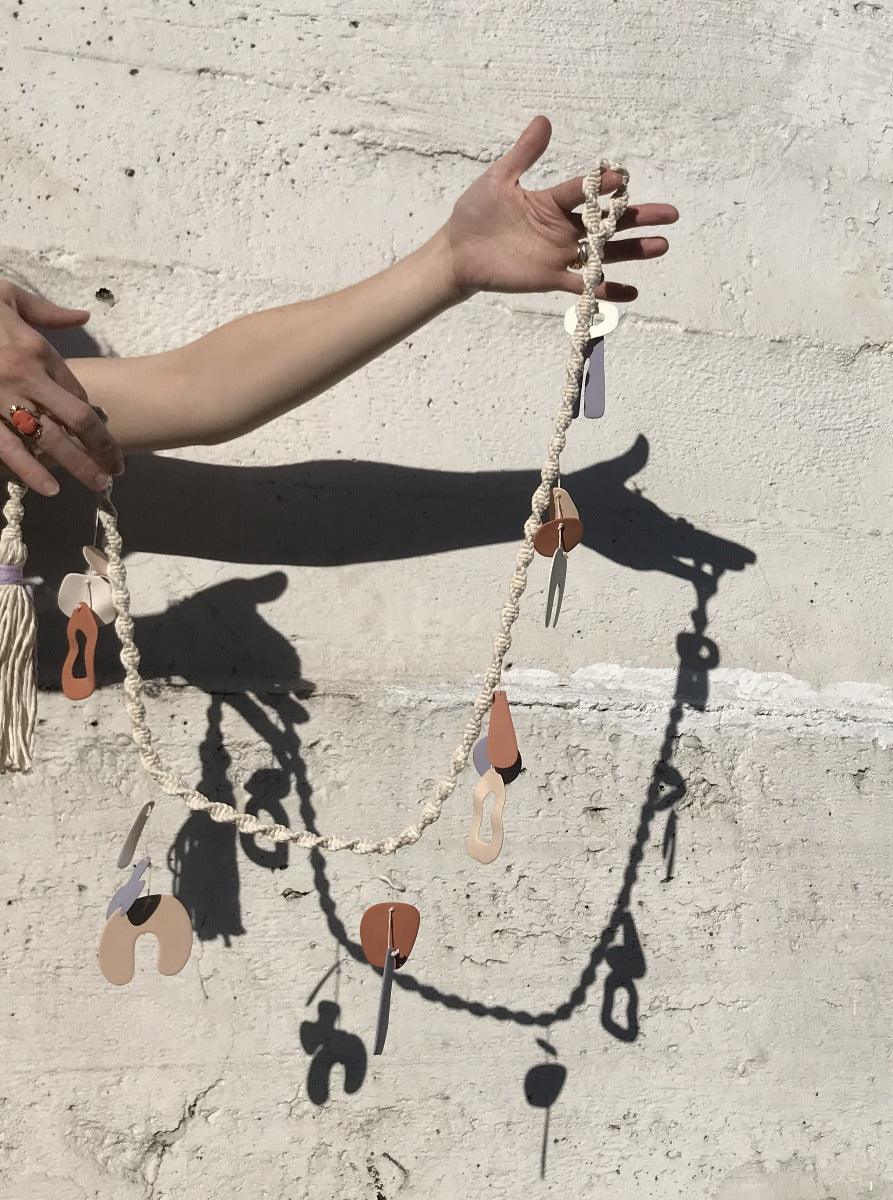 four eyes ceramic chimes in a macrame garland. Ready to ship. 