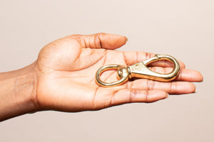 hand holding our brass swivel clip